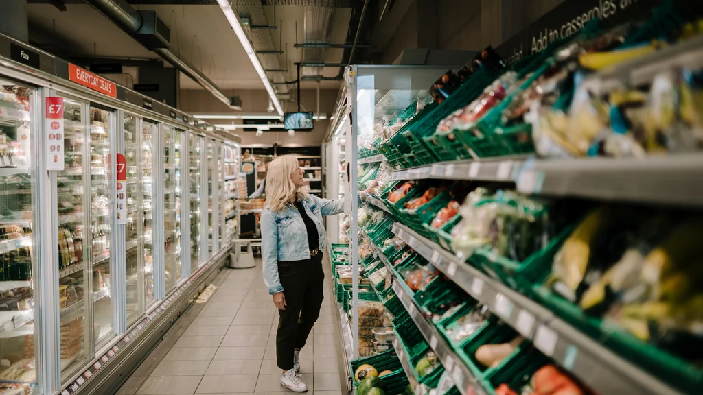 A woman browses shelves at a supermarket