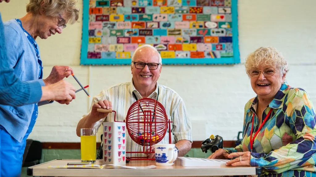 A man and two women play bingo