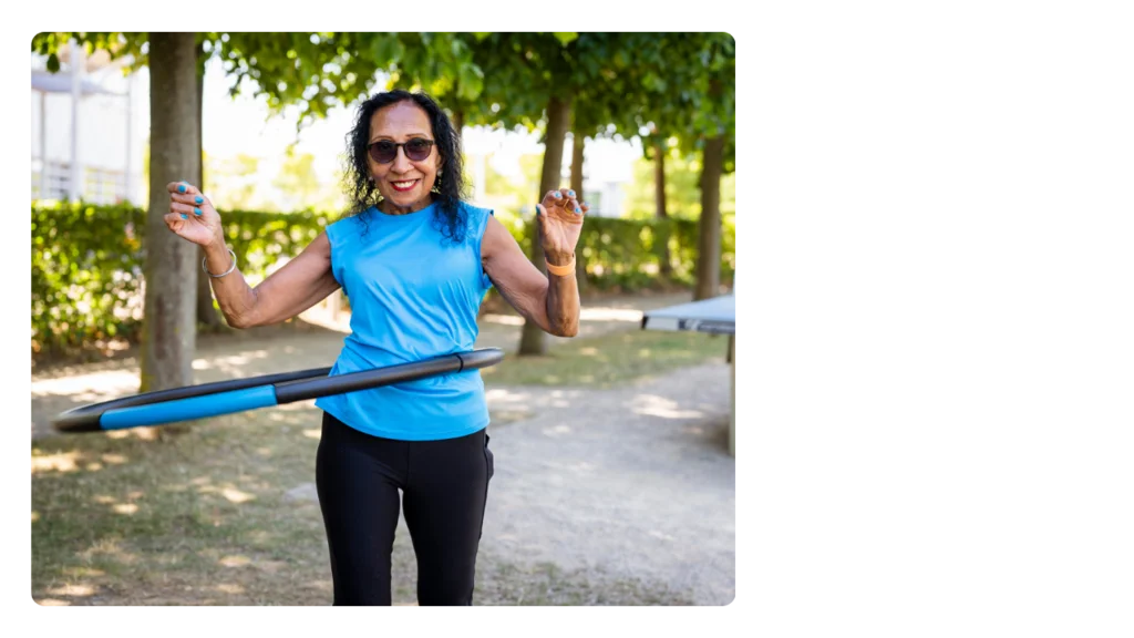 A woman wearing exercise clothes and hoola hooping